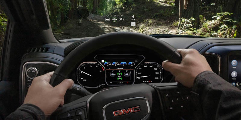 GMC Sierra 2500HD dashboard view and steering tightly holding with hands